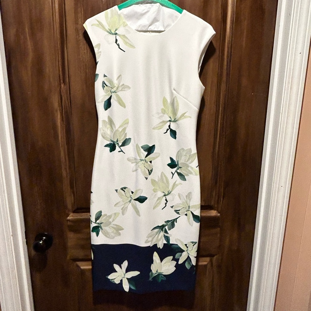 Vince Camuto dress in winter white with floral background and navy border.